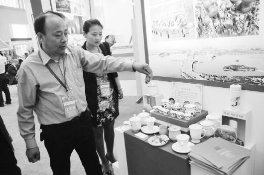 山东海瓷集团的一位负责人向参展者介绍贝瓷。 本报记者 李运恒 摄